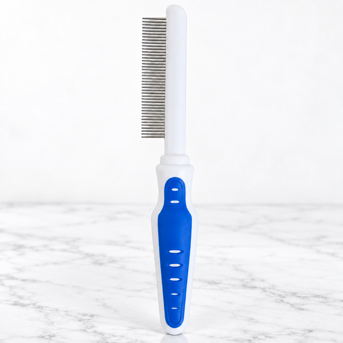 Cat Grooming Comb with Comfort Grip on white marble