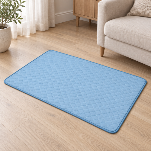 AeroMat blue XL quilted mat beside a linen armchair