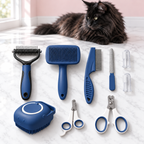Cashmere Comb nine-piece blue grooming set with a black Maine Coon in an empty light pink room on white marble.