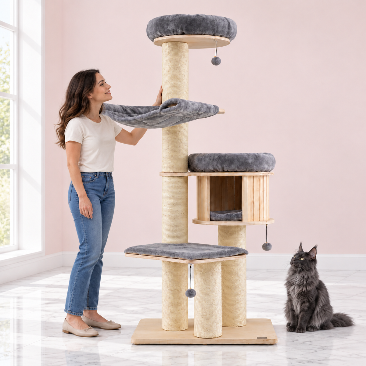 Wooden Cat Tree 68.5 Inches – The Roundhouse in an empty light pink room with white marble flooring and a smoky grey Maine Coon looking toward the product.