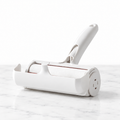 White reusable pet hair roller on subtle white marble