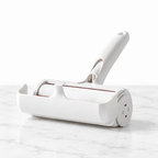 White reusable pet hair roller on subtle white marble