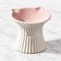 Purr-celain pink and white ceramic cat bowl on subtle white marble