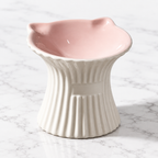 Purr-celain pink and white ceramic cat bowl on subtle white marble