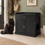 Black drawer litter cabinet beside a full-sized black Norwegian Forest Cat in a sage hallway