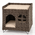 The Foldaway Wicker House on a pale white-marble studio floor