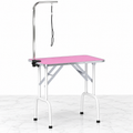 Pink 81 cm folding grooming table on white marble with unused grooming arm and restraint
