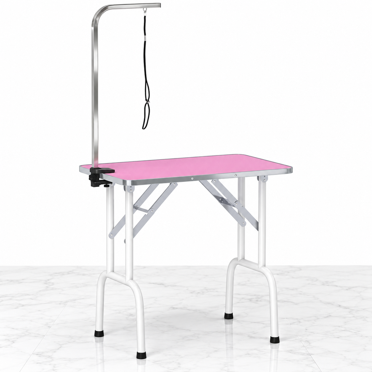 Pink 81 cm folding grooming table on white marble with unused grooming arm and restraint