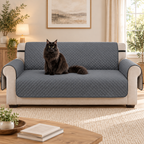 Grey three-seater sofa cover with a black Maine Coon in a warm living room