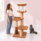 Cat Tree 166 cm – The Amber Rise with a smoky grey Maine Coon and an adult woman facing the tower in an empty light pink room with white marble flooring.