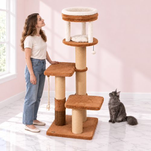 Cat Tree 166 cm – The Amber Rise with a smoky grey Maine Coon and an adult woman facing the tower in an empty light pink room with white marble flooring.