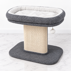 Gray low cat perch with a wide white plush bed and curved sisal scratching board on a white marble floor