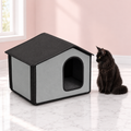 Self-Warming Outdoor Cat House Gray – The Garden Bothy with a black Maine Coon in a pale pink room