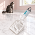 Deluxe 2-In-1 Litter Scoop with Waste Bags – The Tidy Companion with a smoky grey Maine Coon in a pale pink room