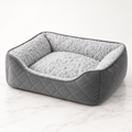 Silver Velvet Nest grey quilted cat bed with silver plush lining on white marble